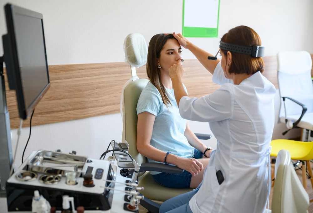 Female ent doctor and patient in office, exam