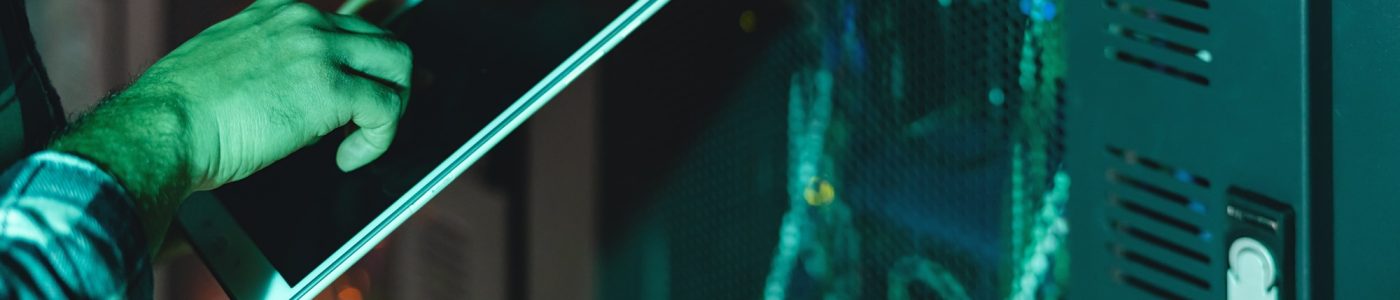 Male informatic engineer working inside server room database