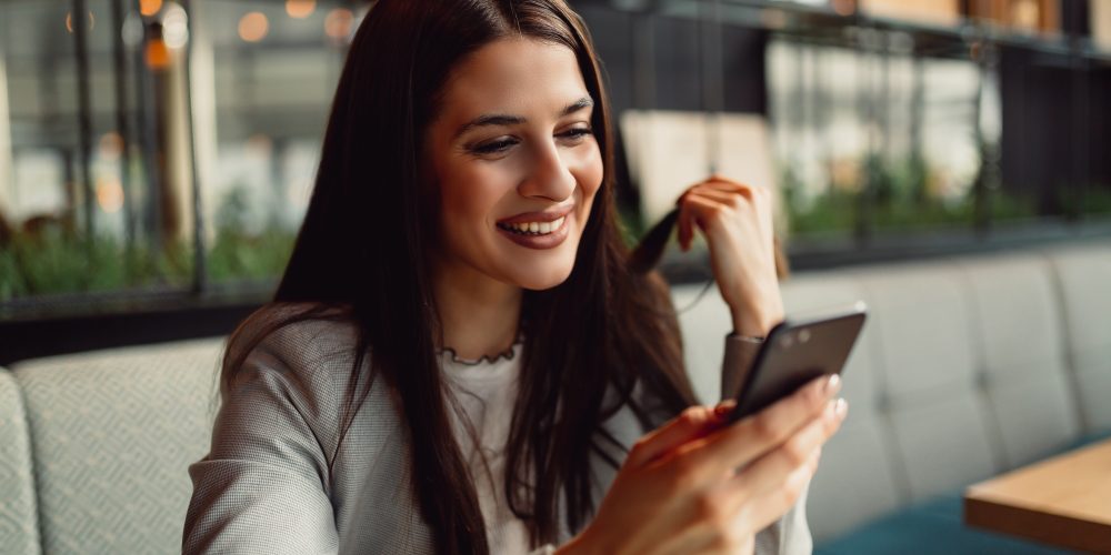 Pretty businesswoman using smart phone.