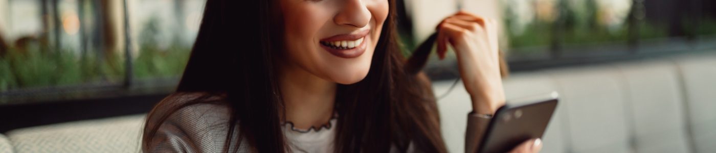 Pretty businesswoman using smart phone.