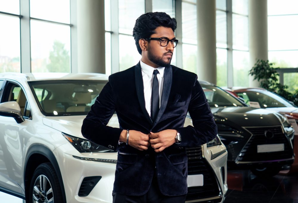 Rich indian businessman in formal wear drive car
