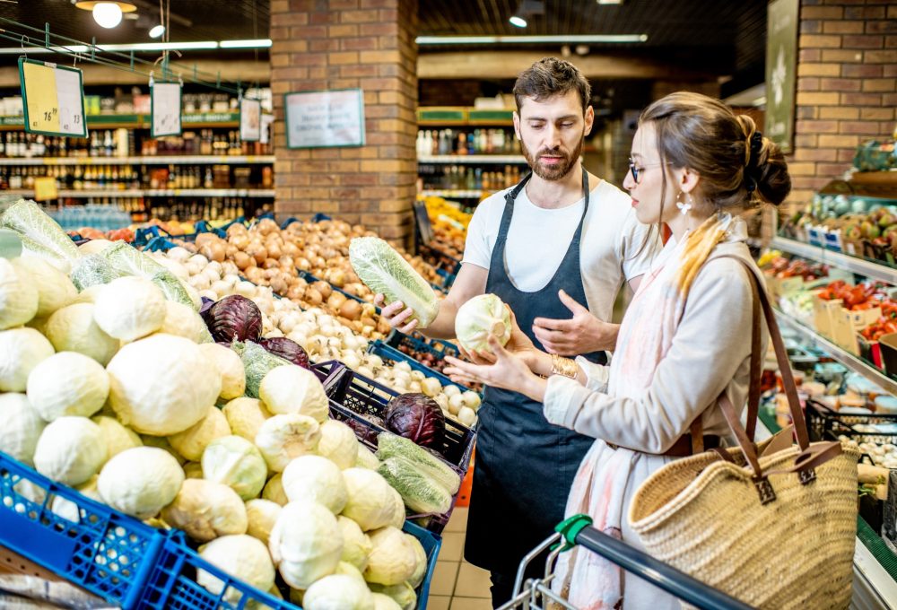 Shop worker with woman in the supermarket