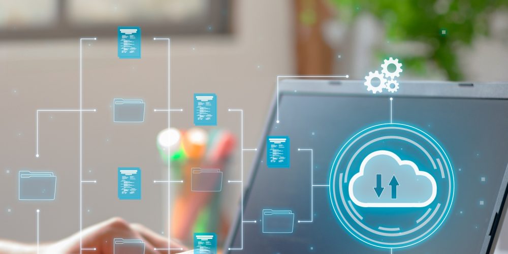 Vertical Photo of A man utilizes cloud computing technology on his laptop for data transmission.