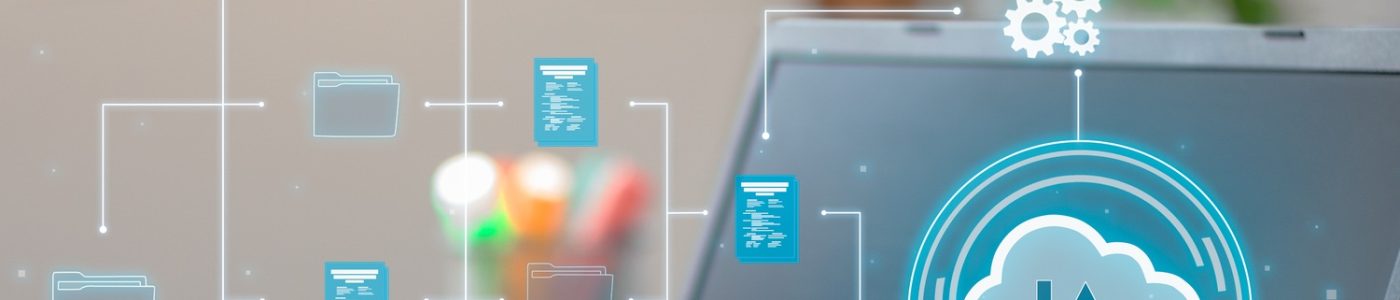 Vertical Photo of A man utilizes cloud computing technology on his laptop for data transmission.